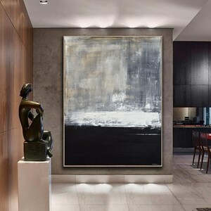 May include: Abstract painting with a black, white, and gray color scheme. The painting is on a large canvas and is hanging on a wall in a modern home.