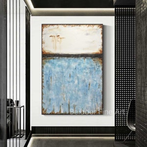 May include: Abstract painting with a blue and brown color scheme. The painting features a horizontal line separating a light brown top section from a blue bottom section. The blue section has a textured, layered look.