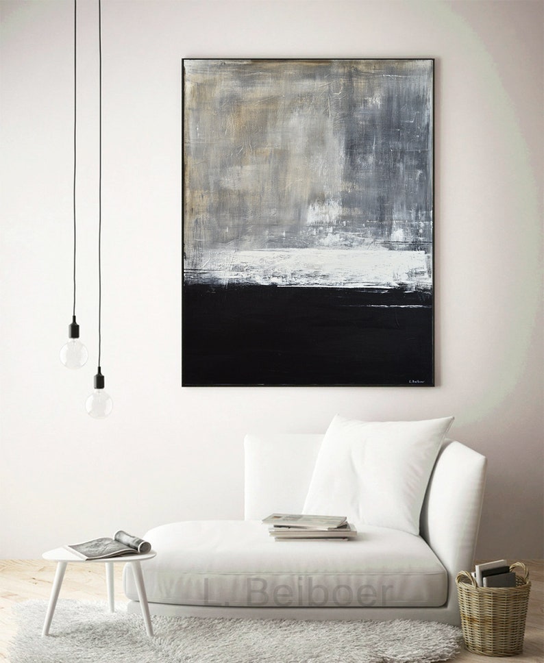 May include: Abstract painting with a white, gray, and black color scheme. The painting is hanging on a white wall above a white couch.