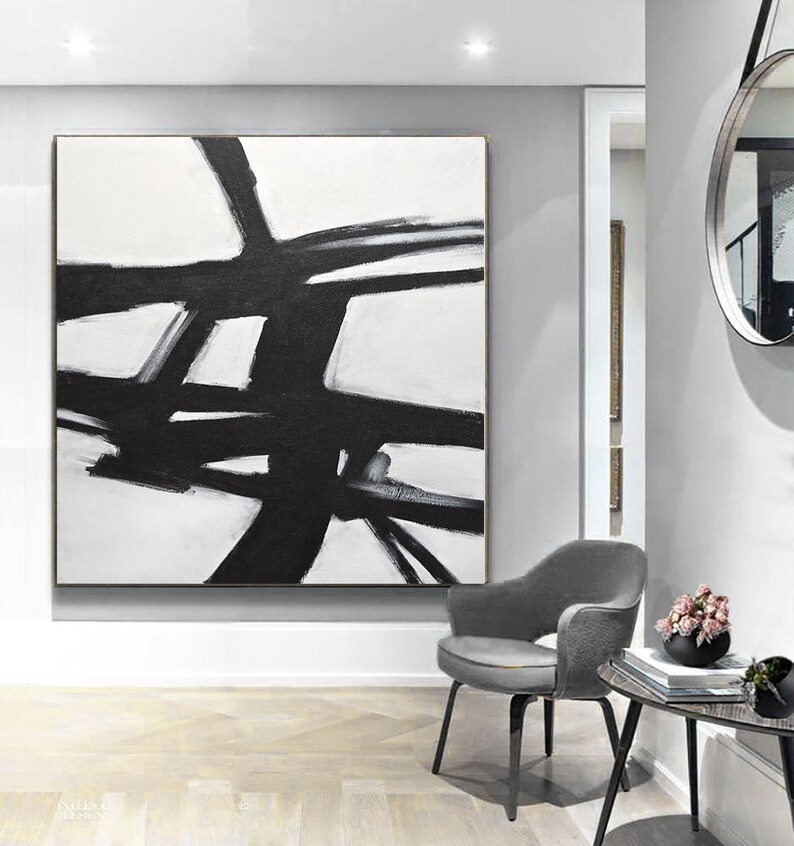 May include: Abstract black and white painting with bold brushstrokes on a white canvas. The painting features a series of intersecting lines and shapes, creating a dynamic and modern design.