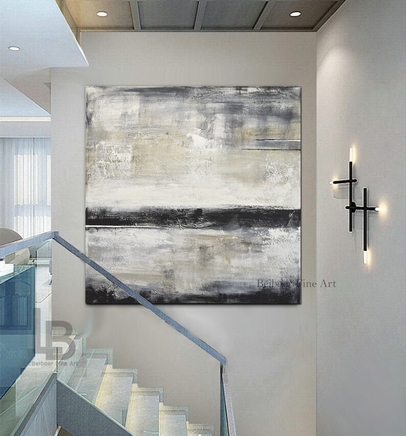 May include: Large abstract painting in neutral tones of gray, black, and beige. The artwork is displayed on a white wall above a staircase with a glass railing. The painting has a textured appearance and is signed by "Belboer Fine Art".