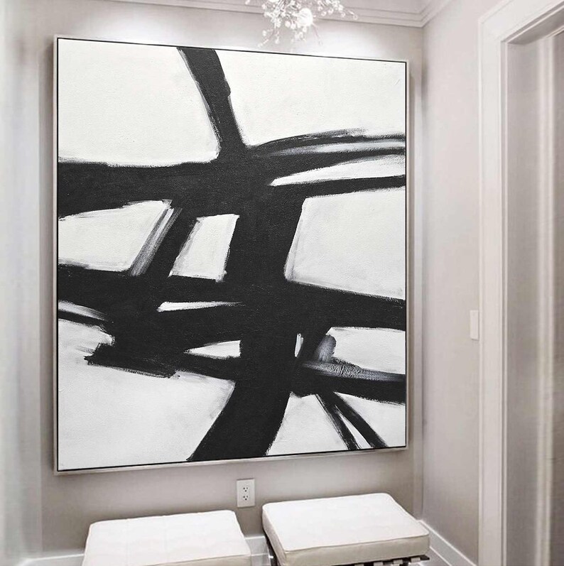 May include: Abstract black and white painting with bold brushstrokes on a white canvas. The painting features a series of intersecting lines and shapes, creating a dynamic and modern composition.