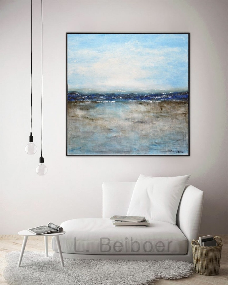 May include: Abstract painting of a seascape with blue and brown hues. The painting depicts a horizon with a blue sky and a brown beach with a blue ocean in the distance. The painting is framed in a black frame and is hanging on a white wall.