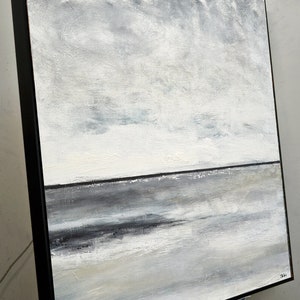 May include: Abstract painting of a seascape with a gray and white color scheme. The painting depicts a horizon line with a dark gray band representing the water and a lighter gray sky above. The sky is filled with subtle brushstrokes and hints of blue.