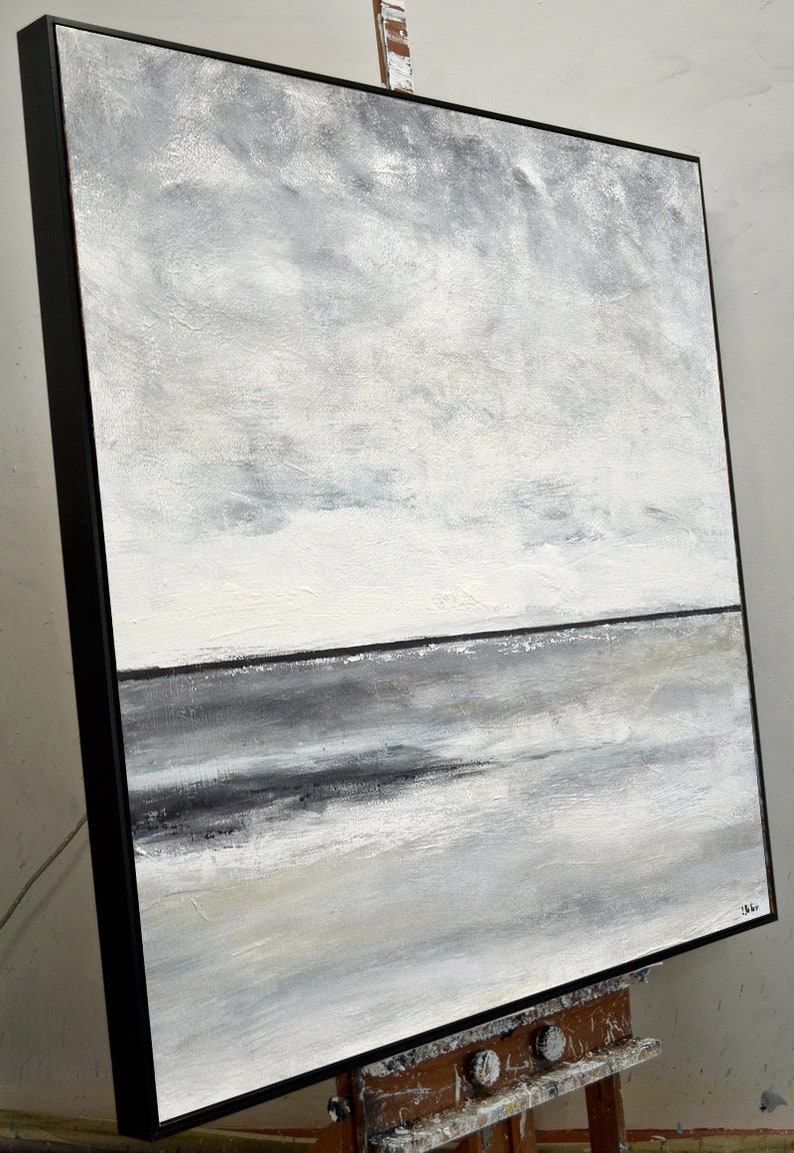 May include: Abstract painting of a seascape with a gray and white color scheme. The painting depicts a horizon line with a dark gray band representing the water and a lighter gray sky above. The sky is filled with subtle brushstrokes and hints of blue.