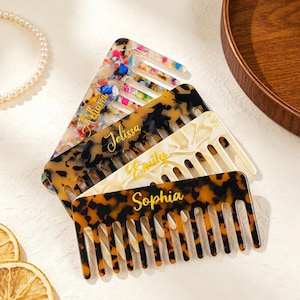 May include: A set of four rectangular hair combs made of acrylic resin with various patterns including multicoloured confetti, black and brown tortoiseshell, and cream marble. Each comb features a custom name in gold script: Adiana, Jelissa, Emily, and Sophia.