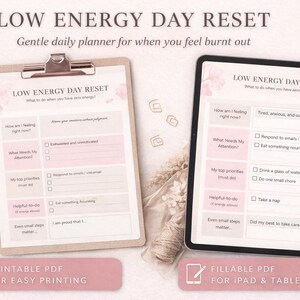 May include: A digital planner titled "Low Energy Day Reset" on a clipboard and a tablet. The planner has pink and white sections with prompts for self-care. Text includes "Printable PDF" and "Fillable PDF for iPad & Tablet Use."