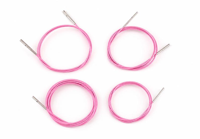 May include: Four pink circular knitting needle cables arranged in a grid. Each flexible cable features a smooth, metallic silver connector at both ends, designed for attaching interchangeable needle tips to create various circular knitting projects.