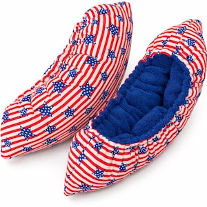 May include: Pair of patriotic red, white, and blue shoe covers. The covers feature a pattern of red and white stripes with blue stars. The interior is a solid blue fabric. These covers are designed to protect shoes.