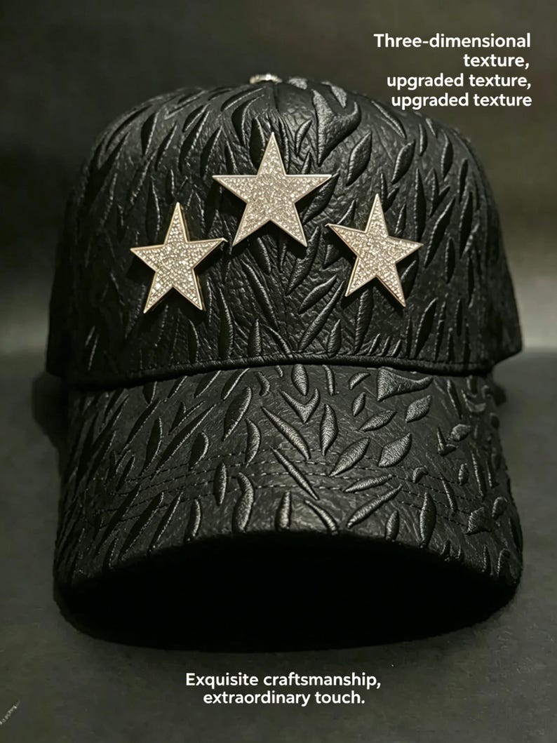 May include: Black baseball cap with a textured pattern and three silver star embellishments. The stars are encrusted with small, sparkling crystals. The cap has a curved brim and a structured design.