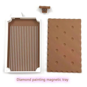 May include: A diamond painting magnetic tray set. The set includes a brown tray with vertical grooves, a brown tray with circular indentations, and a small wooden magnetic piece. The text "Diamond painting magnetic tray" is at the bottom.