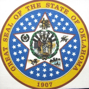 May include: The Great Seal of the State of Oklahoma features a five-pointed star with a blue background and white stars. The seal is surrounded by a gold circle with the words "Great Seal of the State of Oklahoma" and the year "1907".