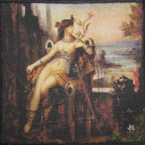 May include: A vintage-style embroidered patch featuring a woman in a flowing gown, holding a flower, with a seascape in the background.