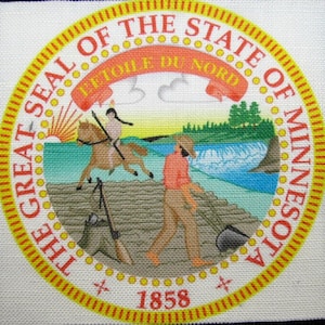 May include: The Great Seal of the State of Minnesota features a red ribbon with the words "L'Etoile du Nord" in gold lettering, a Native American riding a horse, a man with a shovel, a waterfall, and the year 1858.