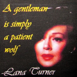 May include: A black canvas with a yellow quote that reads "A gentleman is simply a patient wolf - Lana Turner". A woman's face is visible in the background.