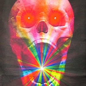 May include: A bright pink and red skull with glowing red eyes and a wide open mouth. The mouth is filled with a colorful, rainbow-like pattern.