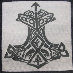 May include: A black and white embroidered patch featuring a stylized Mjolnir, the hammer of Thor, with intricate knotwork designs.