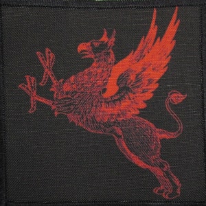 May include: A red embroidered patch featuring a griffin with wings outstretched, set against a black background.