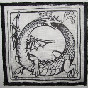 May include: Black and white embroidered patch of a dragon with a crown on its head, breathing fire. The dragon is curled in a circle, with its tail in its mouth.