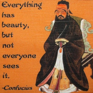 May include: A quote by Confucius on a canvas background. The quote reads "Everything has beauty, but not everyone sees it." The quote is in black text on an orange background. A painting of Confucius is on the right side of the image.