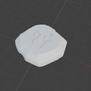 May include: A light gray, irregularly shaped object with two stylized, curved markings on its surface. The object appears to be a 3D model or a digital rendering, possibly a decorative element or a design component.