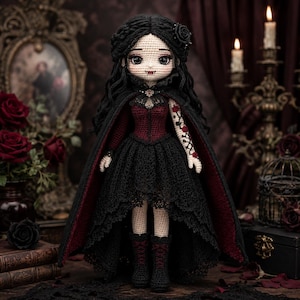 May include: A handcrafted crochet doll featuring long black hair with a rose accessory, wearing a dark red and black lace-trimmed dress, a matching cape, and black boots. The doll has pale skin, large dark eyes, and visible fangs, with a floral tattoo design on one arm.