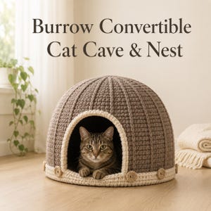 May include: A brown and cream crocheted dome-shaped cat cave with a ribbed texture and small circular accents along the base. A tabby cat sits inside the opening. The text above reads: Burrow Convertible Cat Cave & Nest.