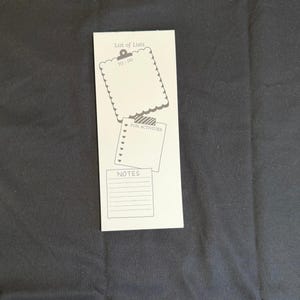 May include: A white rectangular notepad featuring the header List of Lists. It includes a scalloped-edge TO-DO section with a clipboard icon, a FUN ACTIVITIES section with a list of hearts, and a lined NOTES section at the bottom.