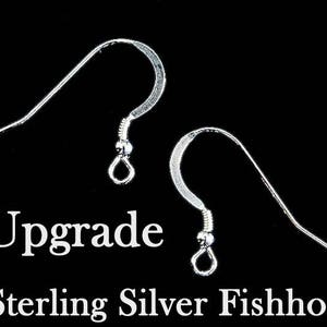 May include: Two silver fishhook earring findings. The text "Upgrade to Sterling Silver Fishhooks" is below the image.