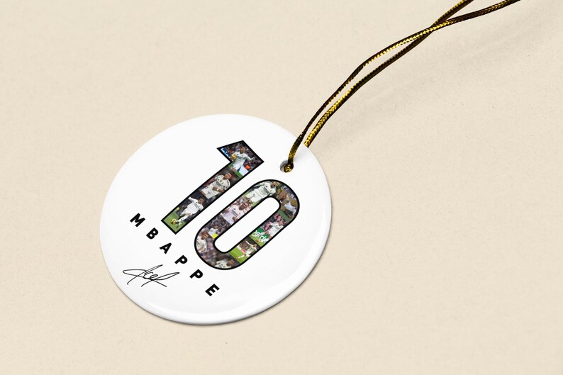 A white circular tag with the number "10" and the text "MBAPE" printed on it, along with a signature.