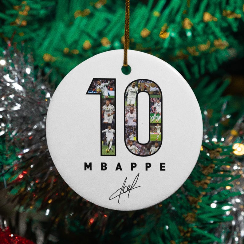 A white ornament with the number 10 and the text "MBAPPE" hanging on a Christmas tree.