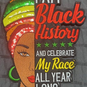 May include: An embroidered patch featuring the left side of a face with a green, yellow, and red sequined headwrap and a green hoop earring. The text reads I AM Black History AND CELEBRATE My Race ALL YEAR LONG with five green stars.