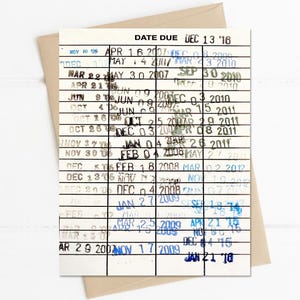 May include: A rectangular library date due card featuring black horizontal lines and vertical columns. The card is printed with the text DATE DUE DEC 13 '16 at the top and contains numerous stamped dates in black and blue ink across the grid.