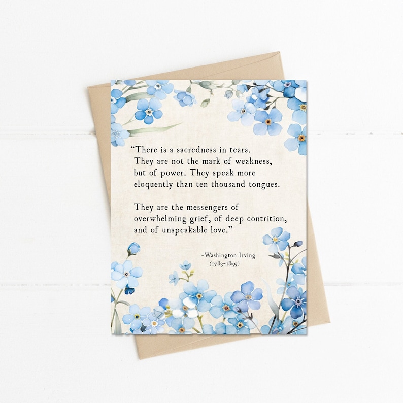 May include: A card with a quote about tears being a sign of power, not weakness, by Washington Irving. The quote is surrounded by blue forget-me-not flowers on a white background.