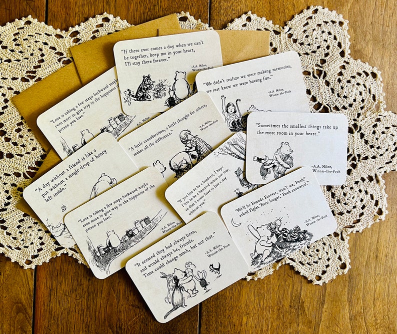 May include: A collection of Winnie-the-Pooh themed cards with quotes from the book. The cards feature black and white illustrations of Winnie-the-Pooh and his friends. The quotes include: "Love is taking a few steps backward maybe even more to give way to the happiness of the person you love." "If there ever comes a day when we can't be together, keep me in your heart, I'll stay there forever." "A day without a friend is like a pot without a single drop of honey left inside." "A late consideration, a little thought for others, makes all the difference." "We didn't realize we were making memories, we just knew we were having fun." "Sometimes the smallest things take up the most room in your heart." "We'll be Friends Forever, won't we?" asked Piglet. "Even longer," Pooh answered.