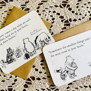 May include: Two Winnie-the-Pooh themed cards with black and white illustrations and quotes. The first card says "If there ever comes a day when we can't be together, keep me in your heart, I'll stay there forever." The second card says "Sometimes the smallest things take up the most room in your heart."