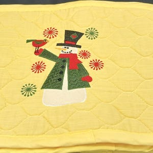 Set of 4 yellow placemats with cute snowman design.