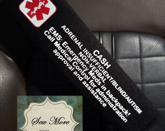 May include: Black seatbelt strap with a red star of life and white text that reads "CASH ADRENAL INSUFFICIENT/BLIND/AUTISM NON-VERBAL EMS: Emergency Meds in backpack! Call Medical Control for administration approval and assistance".