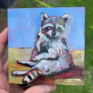 4x4 Original Oil Painting of a raccoon eating popcorn on couch funny trash panda animal art texture North Carolina artist leitner studios
