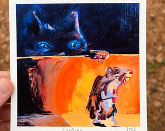 May include: A painting of a black cat with blue eyes peeking over a wall, looking down at a small gray mouse with a red object in its mouth. The background is dark blue and the wall is orange. The painting is titled "Lurking" and signed "JPB1".