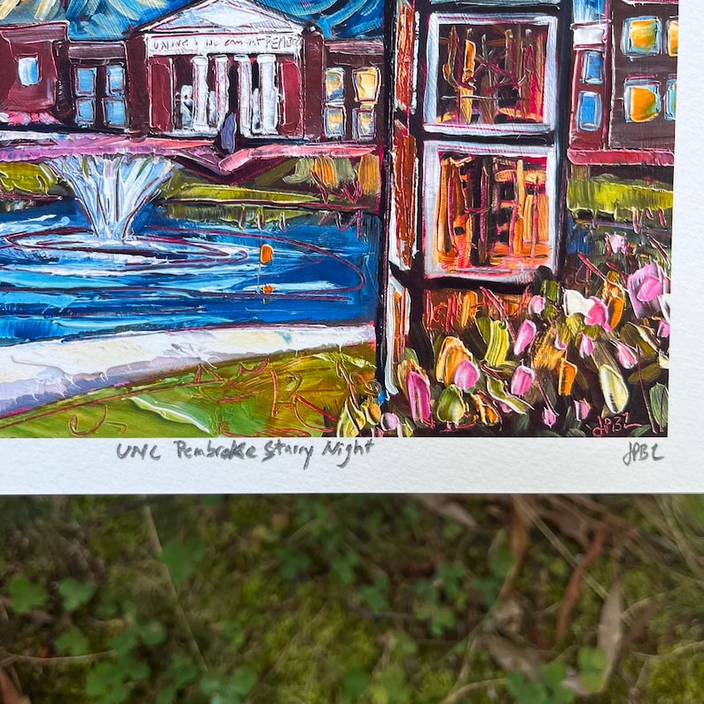 May include: An impressionistic painting of a university campus at night. The artwork features a fountain, buildings, and colorful brushstrokes. The text "UNC Pembroke Starry Night" is visible at the bottom.