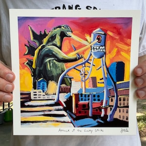 May include: A painting of a green Godzilla-like monster attacking a large, blue, mechanical structure with a red eye. The scene is set against a yellow and orange sunset sky. The painting is titled "Attack of the Lucky Strike".