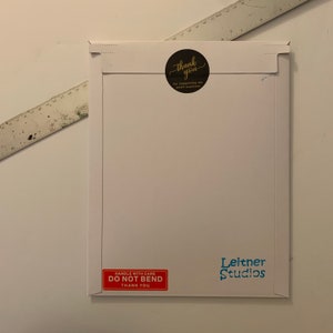 May include: White envelope with a red "Handle with Care, Do Not Bend, Thank You" sticker and a blue "Leitner Studios" sticker. A black circle sticker with gold lettering says "Thank you for supporting my small business."