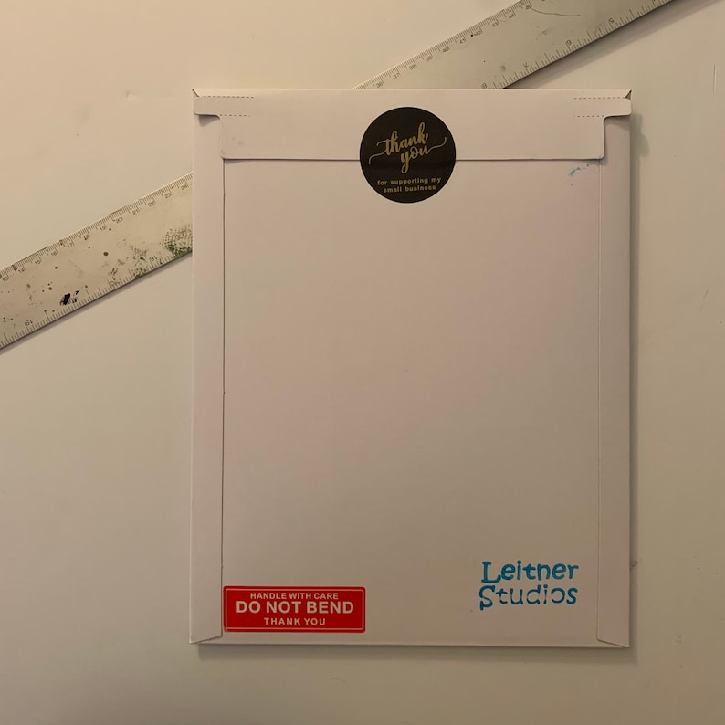 May include: White envelope with a red "Handle with Care, Do Not Bend, Thank You" sticker and a blue "Leitner Studios" sticker. A black circle sticker with gold lettering says "Thank you for supporting my small business."