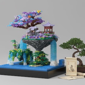 May include: A miniature Japanese-style landscape constructed from colorful building blocks. The scene includes a floating island with a pagoda, waterfall, and bonsai tree. The base is blue, with a black border. A scroll and a bonsai tree are on the right.