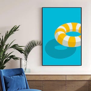 May include: A framed art print depicting a yellow and white striped life ring on a turquoise background. The artwork has a minimalist design with a shadow effect, suggesting summer and leisure. The print is set against a light blue wall, creating a vibrant contrast.