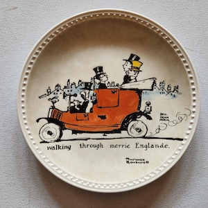 May include: A decorative plate with a cartoon illustration of a vintage orange car carrying passengers wearing top hats. The plate has a white border with a dotted design and the text "walking through merrie Englande."