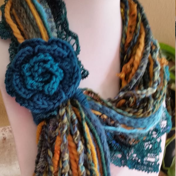 Fringe Scarf-Peacock -Teal, blue/green, aqua, golden tones with a crocheted flower