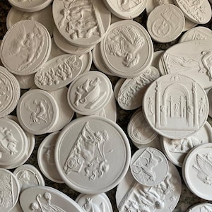 May include: A collection of white plaster relief plaques in various shapes, including round and oval. The plaques feature classical figures, architectural elements, and allegorical scenes. The collection is ideal for home decor.