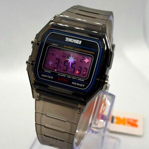 May include: A digital wristwatch with a translucent dark grey resin case and matching link strap. The rectangular face features a black border, the text SKMEI, ALARM CHRONOGRAPH, and WATER 50M RESIST, with a purple digital display showing star icons.